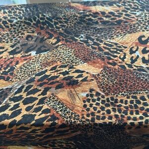 Textured leopard print fabric with brown, orange, and black hues. 45” by 41”